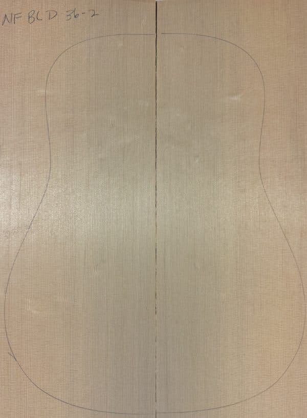 Two light-colored wood planks, prepared as **Non-Figured One-of-a-Kind Guitar Tops**, with a pencil outline of a guitar body.