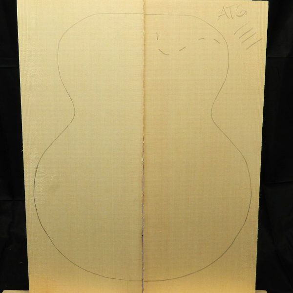 Two pale Master Grade sitka spruce wood planks joined, with a black outline of an archtop guitar body drawn across them.