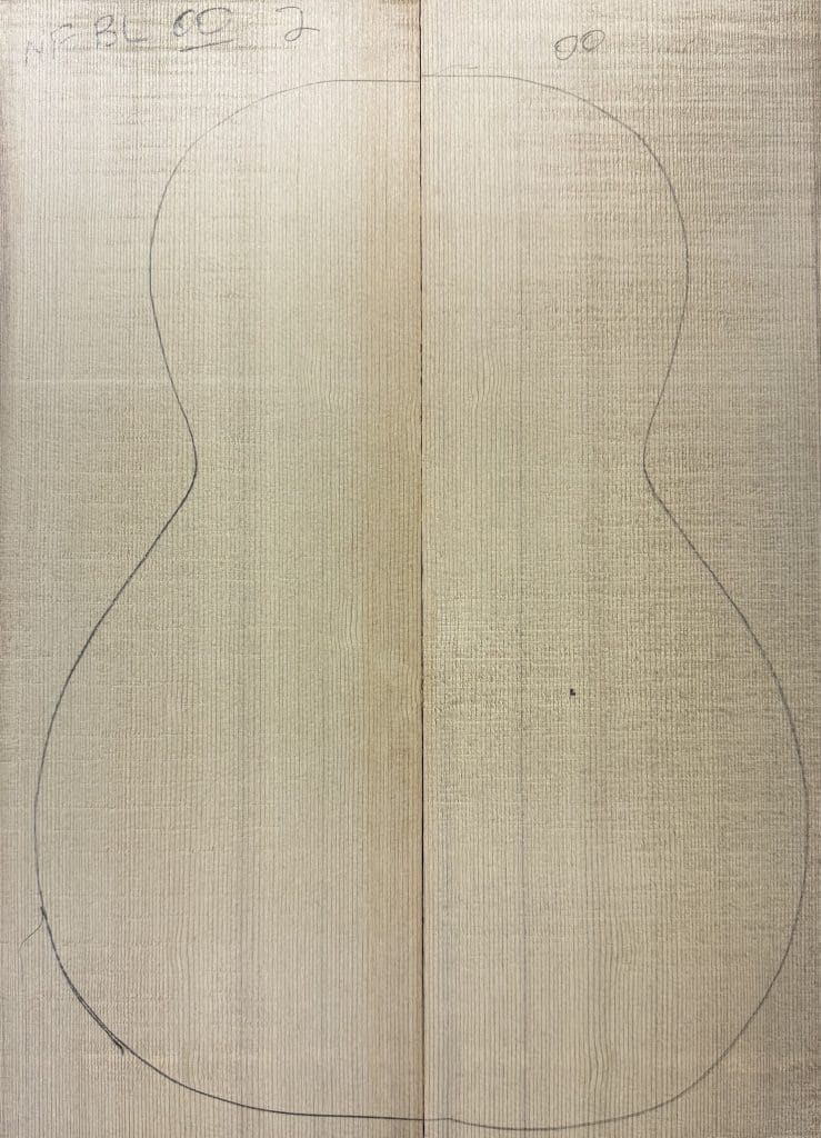 Book-matched light wood panels with a faint pencil outline of a guitar body, perfect for crafting One-of-a-Kind Guitar Tops.