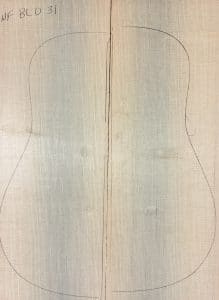 Two matched light spruce wood pieces with a pencil outline of a guitar body, representing One-of-a-Kind Guitar Tops.