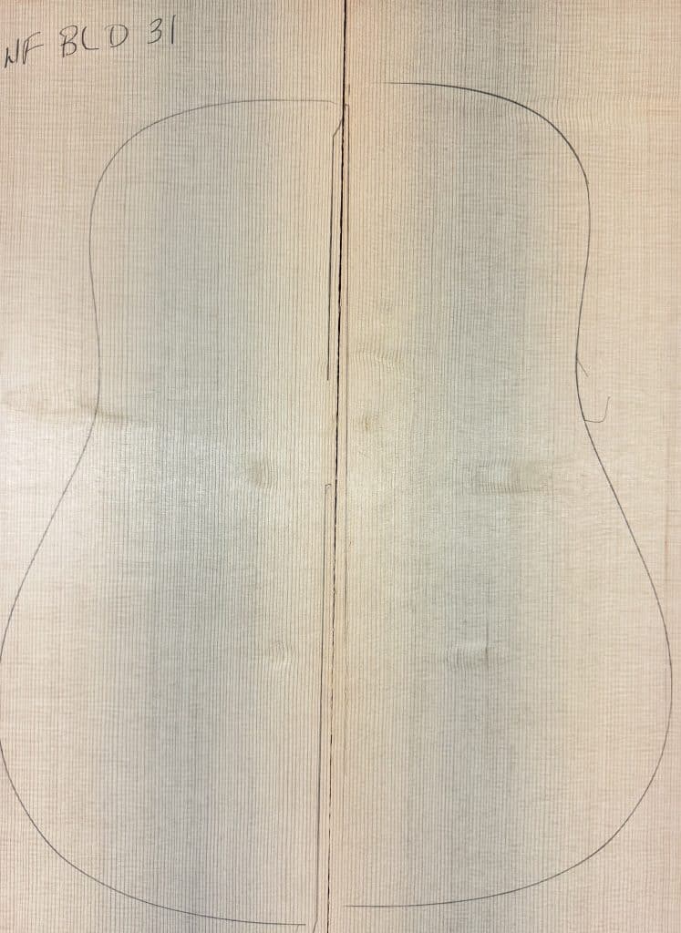 Two matched light spruce wood pieces with a pencil outline of a guitar body, representing One-of-a-Kind Guitar Tops.