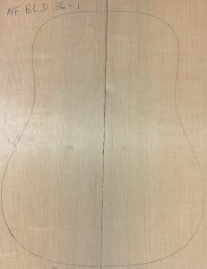 Acoustic guitar body outline drawn on quartersawn wood pieces, showcasing raw material for Blue Non-Figured Guitar Tops.