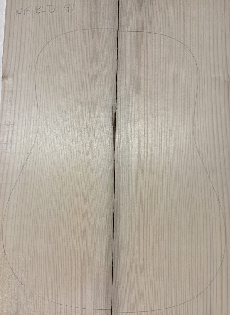 Pale wood panels for One-of-a-Kind Guitar Tops, quartersawn with a fine vertical grain and a pencil outline of an acoustic guitar body, marked 'NF BLD 41'.