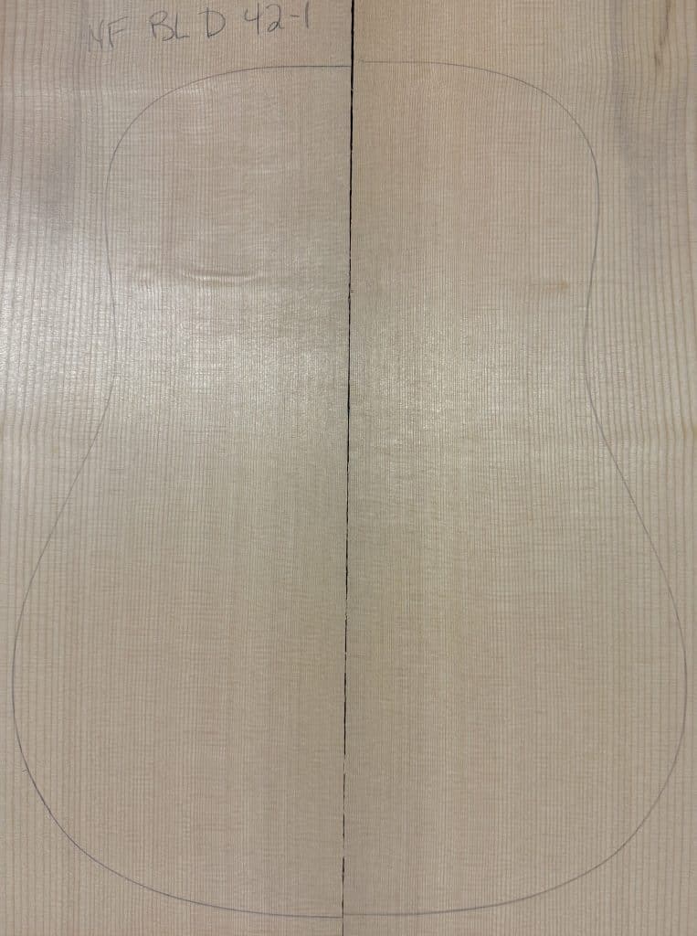 Book-matched light-colored Sitka Spruce tonewood with a guitar outline, ready for Non-Figured Guitar Tops.