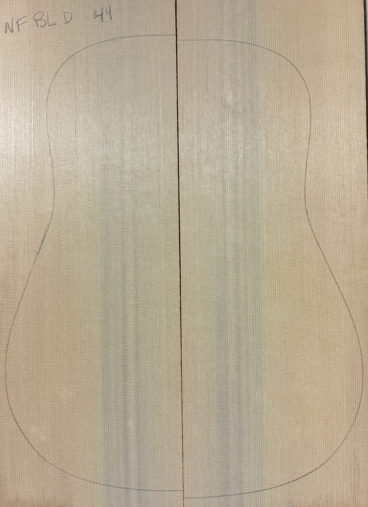 Finely-grained, light-colored wood panel with acoustic guitar outline, labeled 'NF BLD 44', representing premium Non-Figured One-of-a-Kind Guitar Tops.