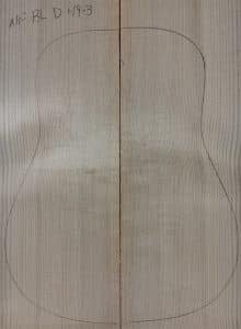 Light-colored reclaimed Sitka Spruce planks, joined with acoustic guitar outline, representing Blue Non-Figured One-of-a-Kind Guitar Tops.