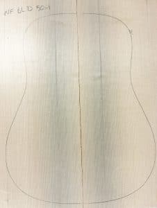 Light-toned, non-figured Sitka Spruce wood panels joined, with a pencil outline for acoustic guitar body, labeled 'NF BLD 50-1', representing One-of-a-Kind Guitar Tops.